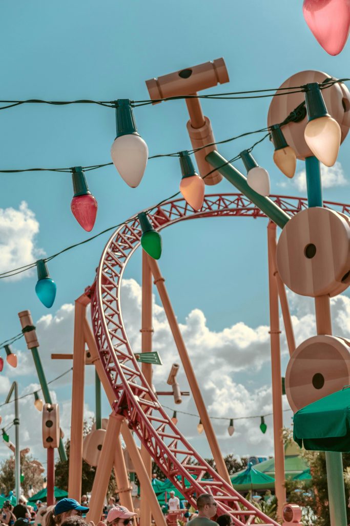 Vibrant roller coaster with string lights in a theme park setting, perfect for a fun-filled day.