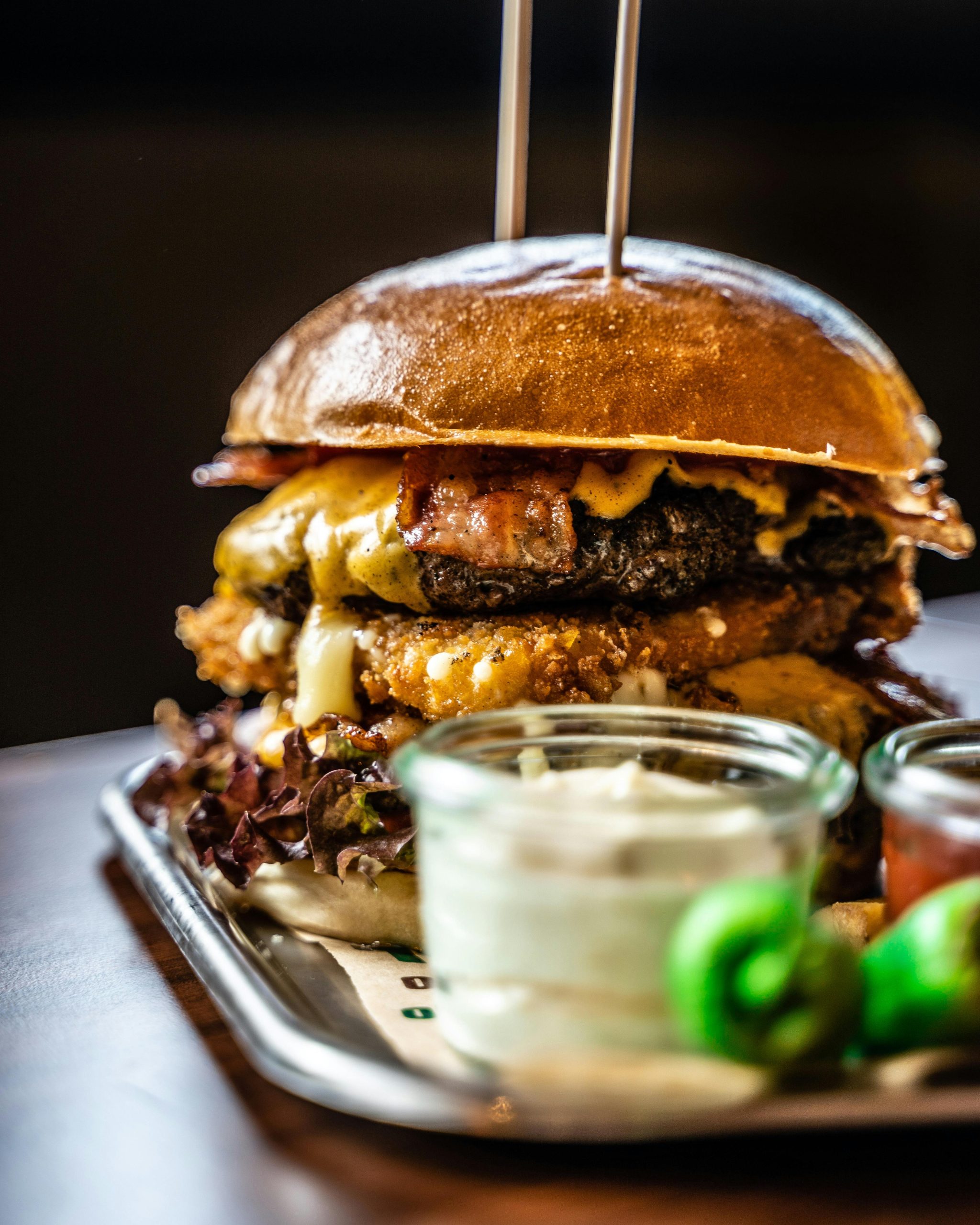 Delicious gourmet cheeseburger paired with fries and dips, perfect for food lovers.